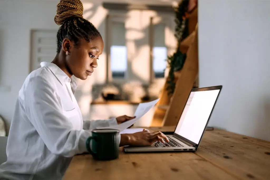 Concentrated young well dressed businesswoman working from home office